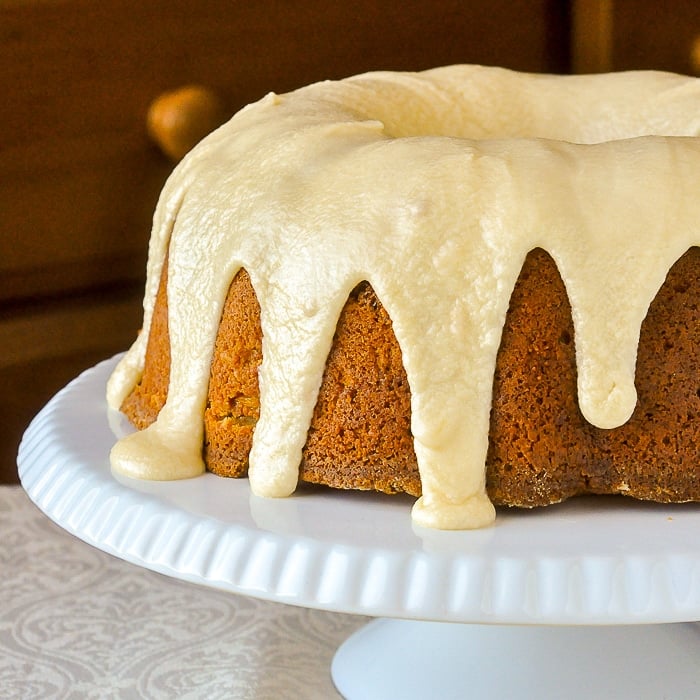 Piña Colada Pineapple Pound Cake photo of uncut cake on a white cake stand