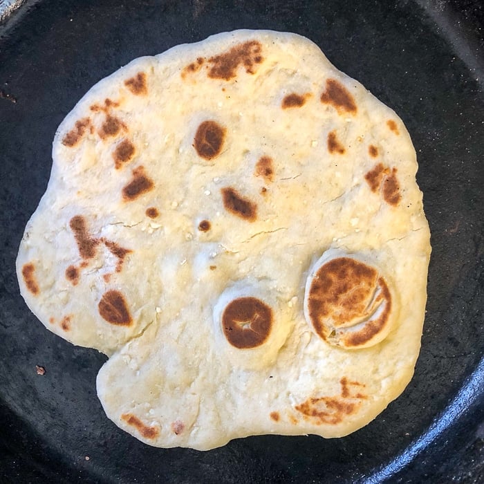 Yogurt Flatbreads are cooked in a cast iron skillet