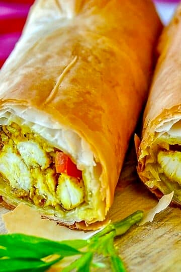 Phyllo Curry Chicken close up photo of pastry cut in half to reveal inside.
