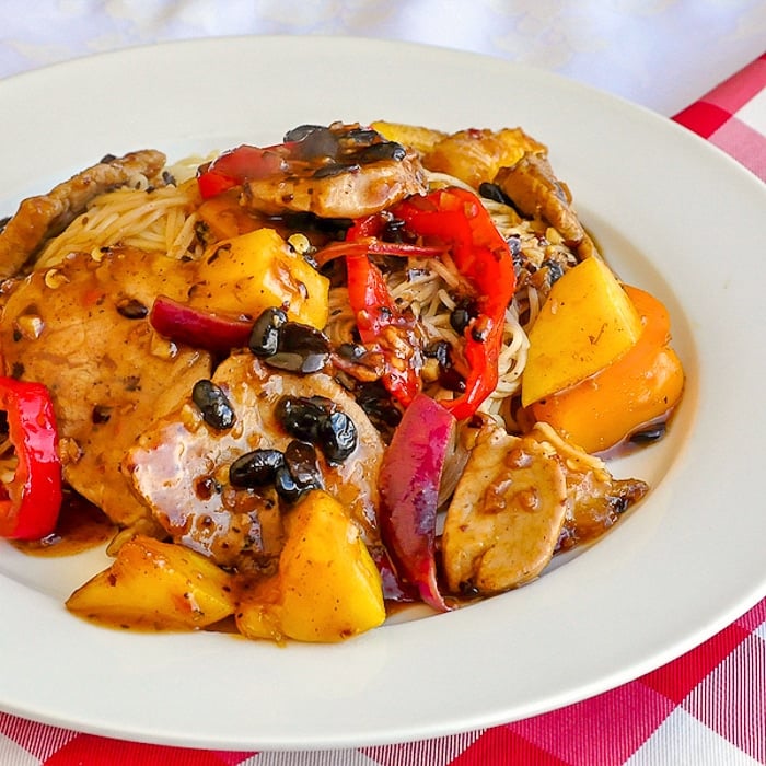 Mango Pork Medallions with Orange Blackbean Sauce close up image on a white plate