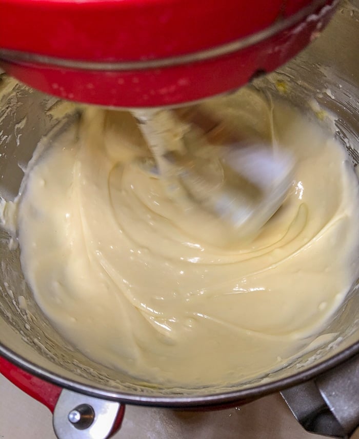 Creaming the butter, cream cheese, sugar and eggs in an electric stand mixer.