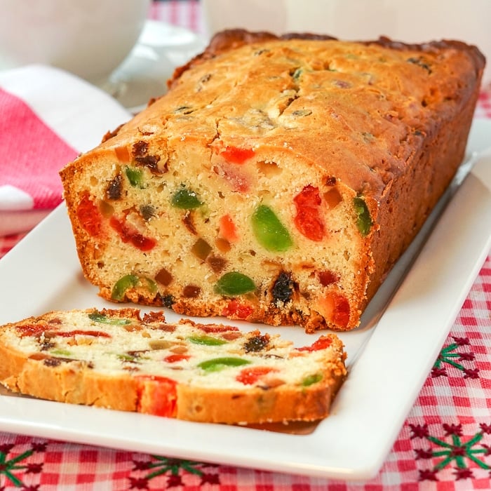 Fruitcake Loaf Cake close up of cut cake and slice on white plate