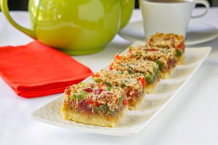 Old Fashioned Cherry Bars shown with a green teapot, red napkin and coffee cup