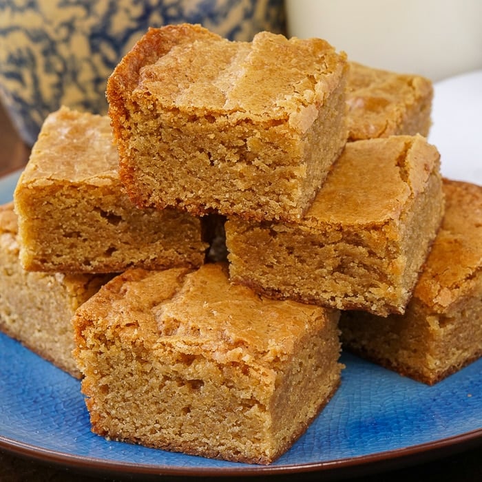 The Best Blondies stacked on a blue plate
