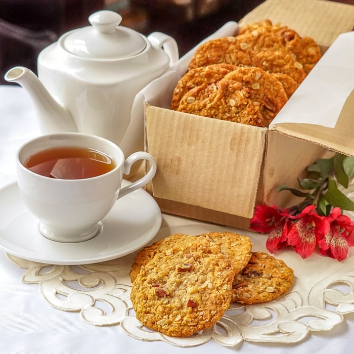 Anzac cookies in a cardboard shipping box with tea service