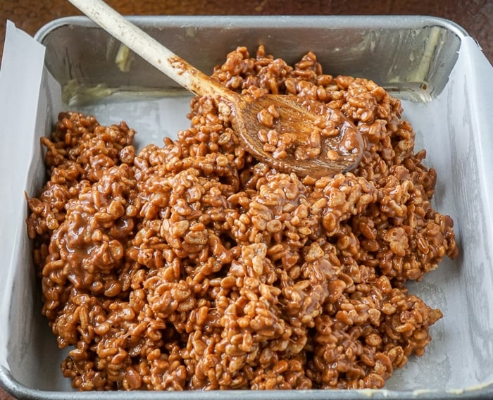 Mars Bar Cookies being pressed into the prepared pan