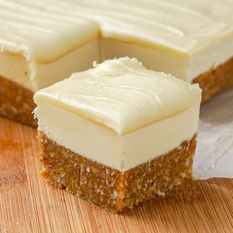 White Chocolate Nanaimo Bars close up photo on a wooden cutting board