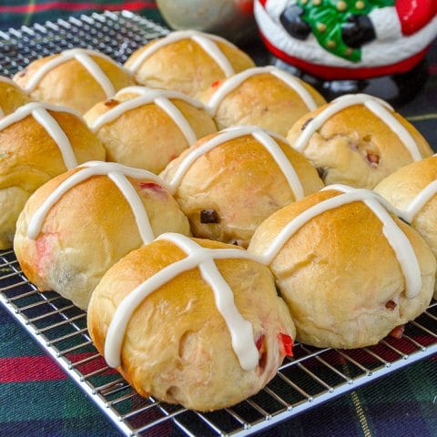 Christmas Hot Cross Buns baked and frosted sitting on a wire cooling rack