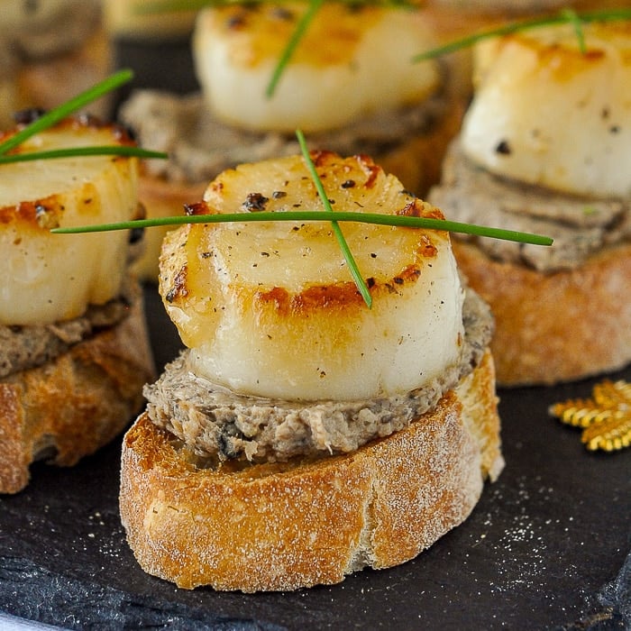 Mushroom Pâté and Seared Scallop Bruschetta close up photo of a single canape
