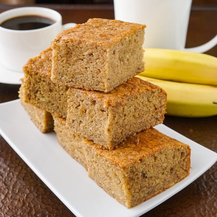 Honey Banana Snack Cake close up photo of cake pieces on white plate