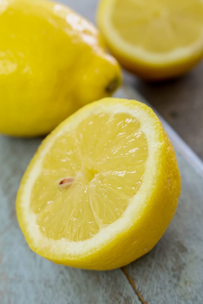 Lemon cut in half on a wooden board