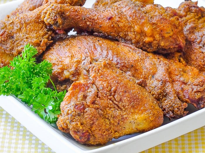 Oven fried Chicken close up photo of cooked chicken pieces.