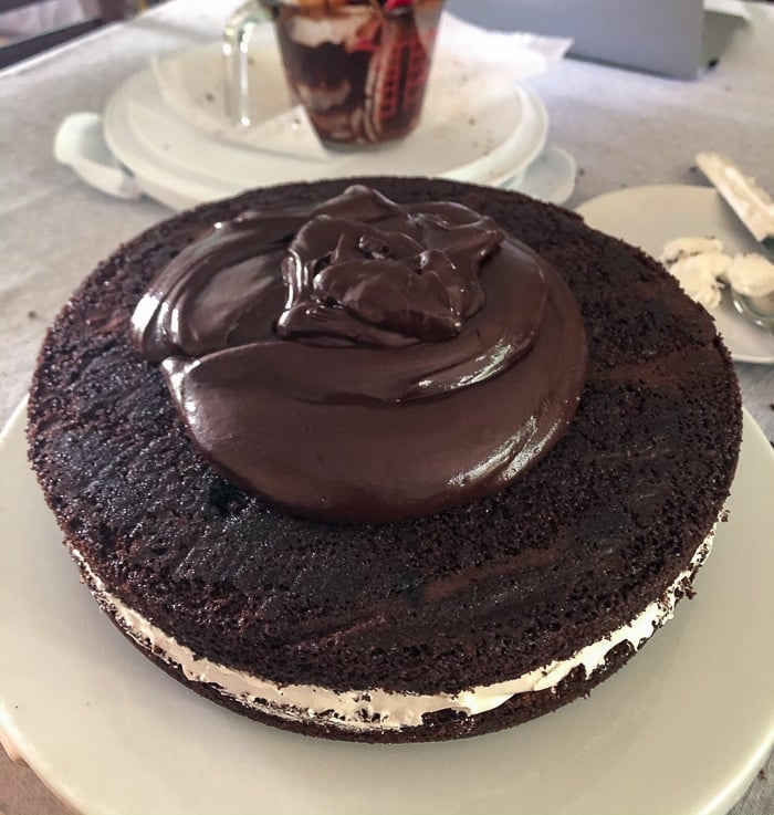 A final chocolate finish being added to the cake