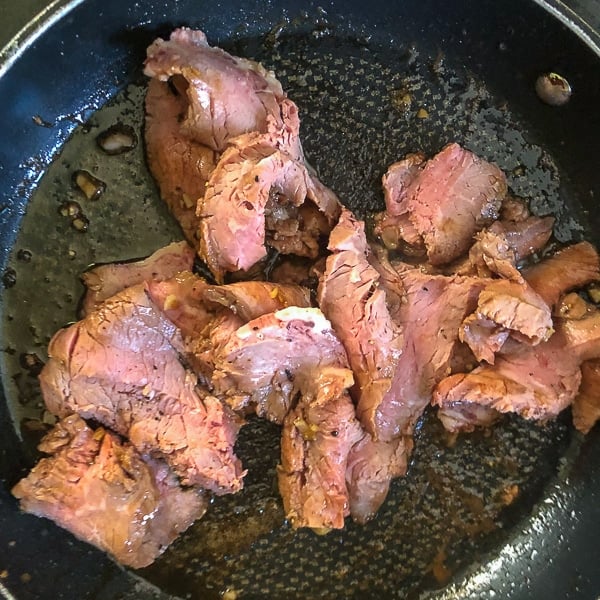 A quick toss of the sliced beef in the glaze in a sauté pan