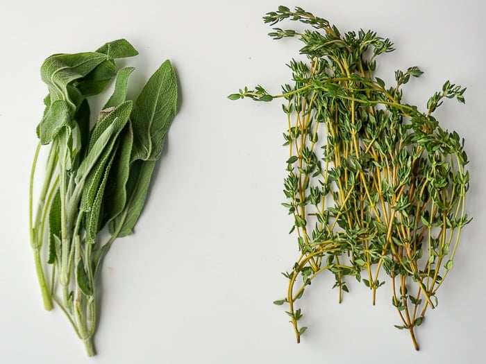 Photo of fresh sage and thyme on a white background