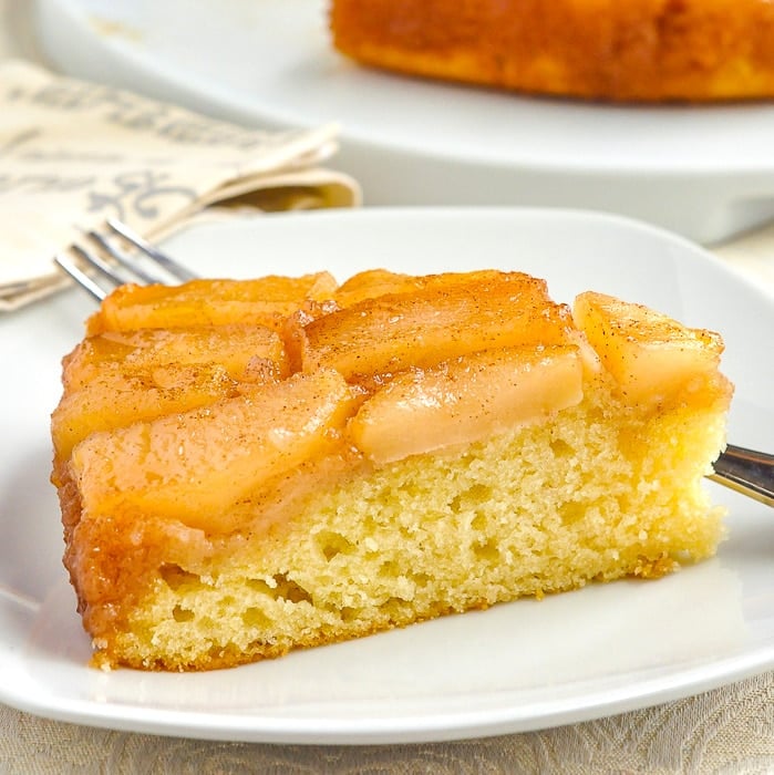 Apple Upside Down Cake close up photo of a single slice on a white plate 1