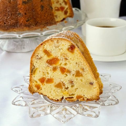 Apricot Hazelnut Pound Cake photo of a single slice on a clear glass dessert plate