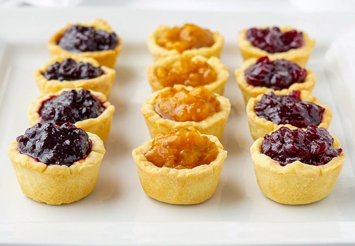 Assorted Jam Tarts on a white serving plate