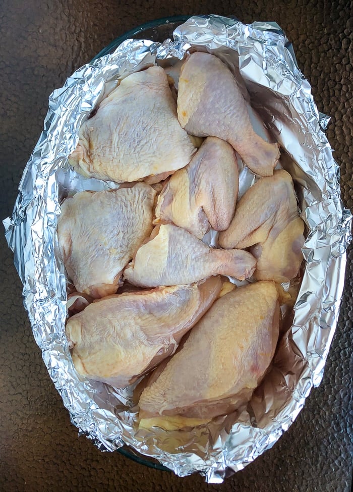 Chicken pieces in a foil lined balking dish