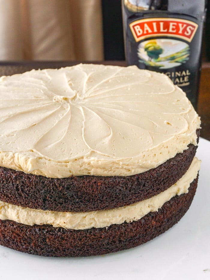 Close up photo of Irish Coffee Cake with Baileys Irish Cream in the background