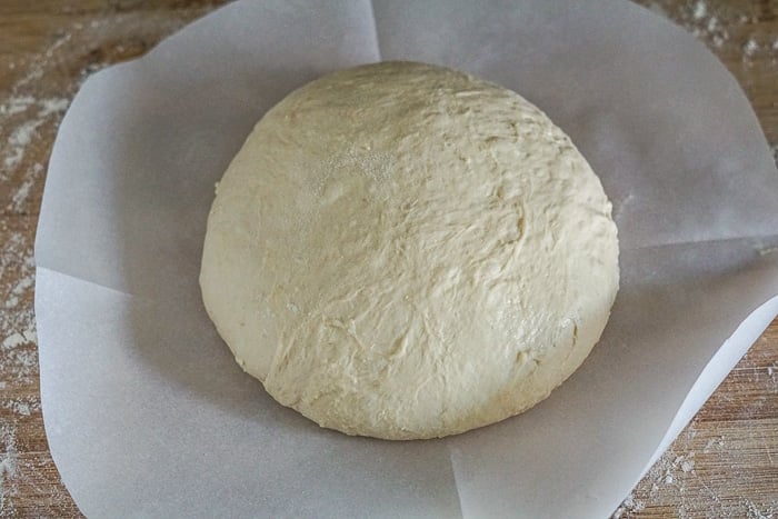 Dough Ball resting on a circle of parchment paper