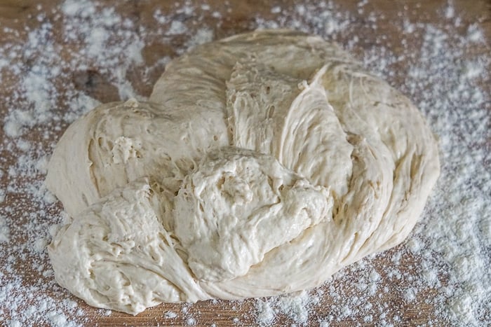 Dough transferred from bowl to well floured surface