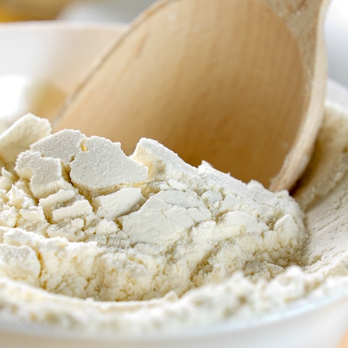 Stock photo od a wooden scoop in flour