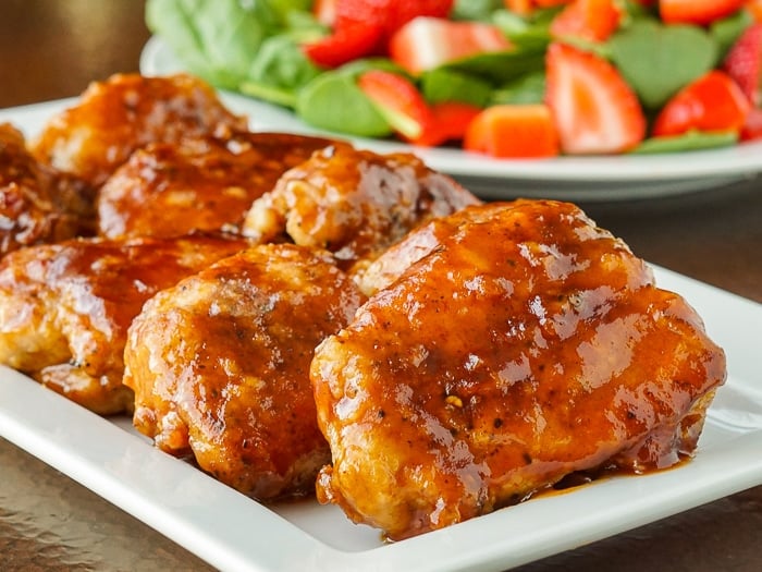 Honey Garlic Barbecue Chicken close up photo of cooked chicken pieces on a white platter