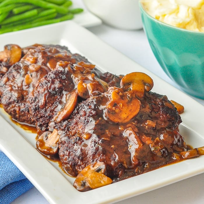 Salisbury Steak close up photo on a white serving platter