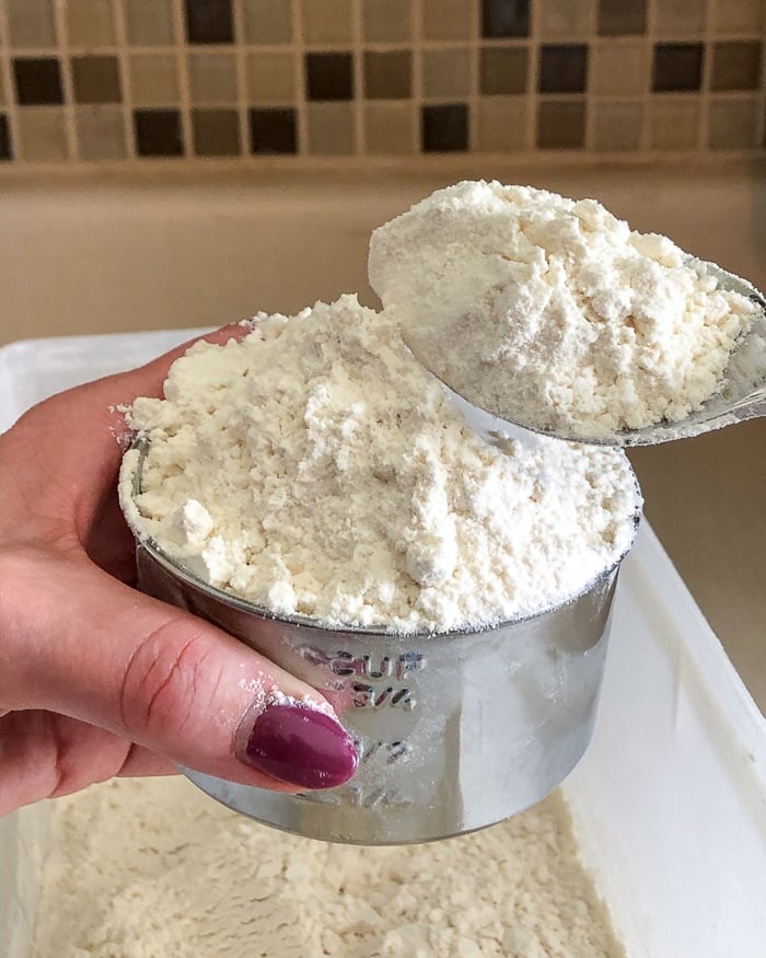 Spooning flour into measuring cup