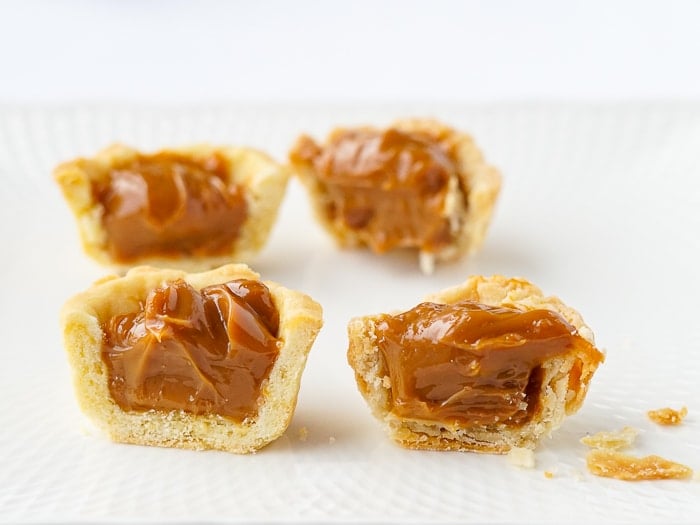 Sweet Shortcrust Pastry and all Butter pastry tarts cut in half to show difference in pastry texture