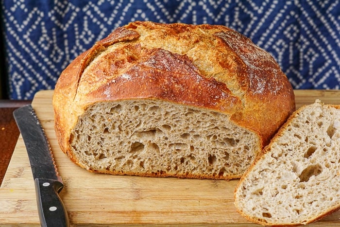 Whole wheat no knead bread on a wooden cutting board