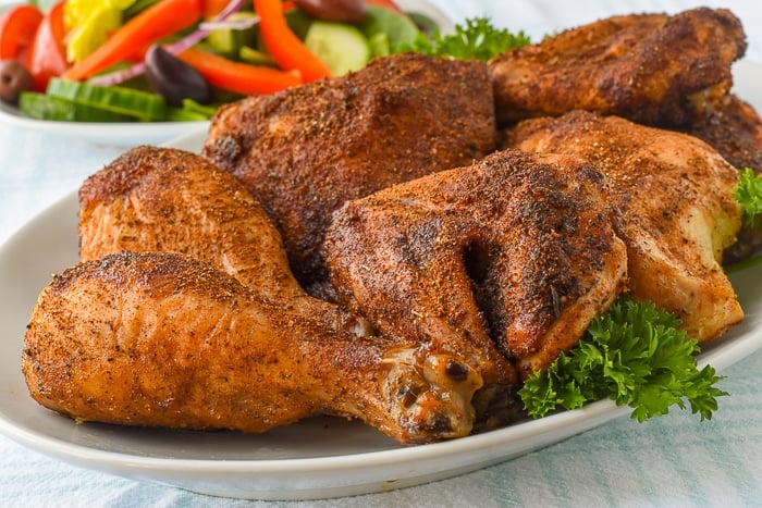 Copycat KFC Roast Chicken close up photo of cooked chicken pieces on a white platter