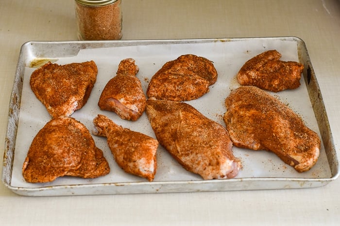 Copycat KFC Roast Chicken on a parchment paper lined baking sheet