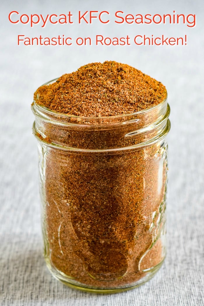 Copycat KFC Seasoning photo of clear glass jar filled with seasoning and with title text added for Pinterest