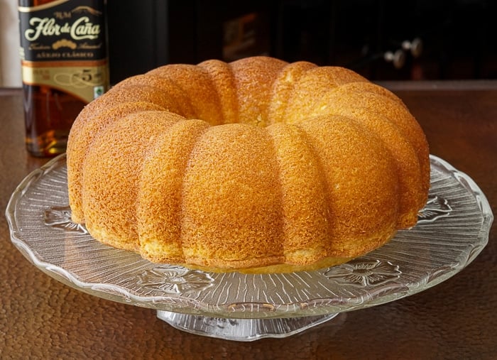 Jamaican Rum Cake photo of uncut cake on a glass stand