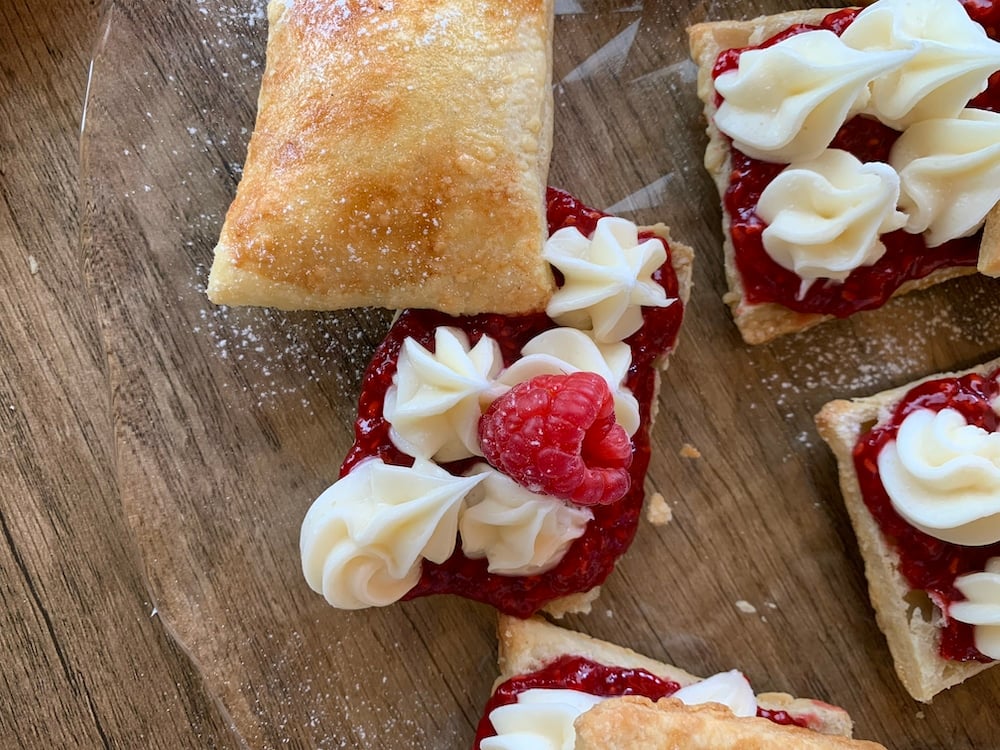 Homemade Flakies with raspberry compote garnished with a raspberry.