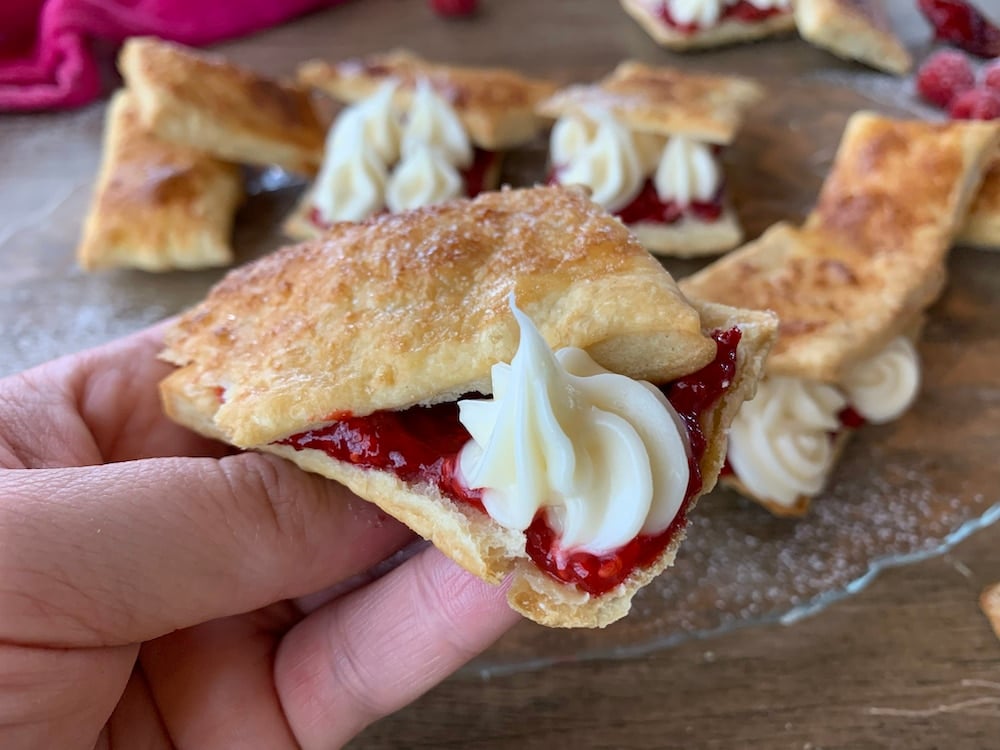 Homemade Flakies with raspberry compote. shown hand held