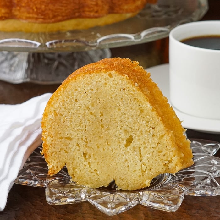 Jamaican Rum Cake photo of a single slice on a clear glass plate
