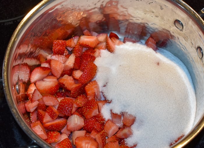 Add the strawberries and sugar to a pot