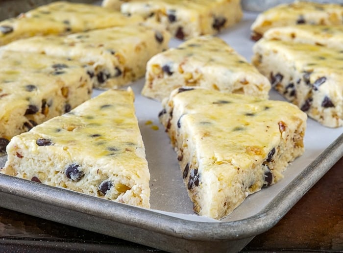 Scones on a parchment lined baking sheet, ready for the oven.