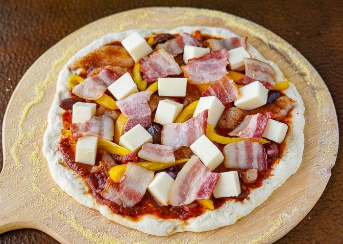 Pizza with toppings ready for the oven.