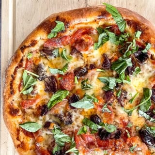 Prosciutto and Pepperoni pizza close up photo.