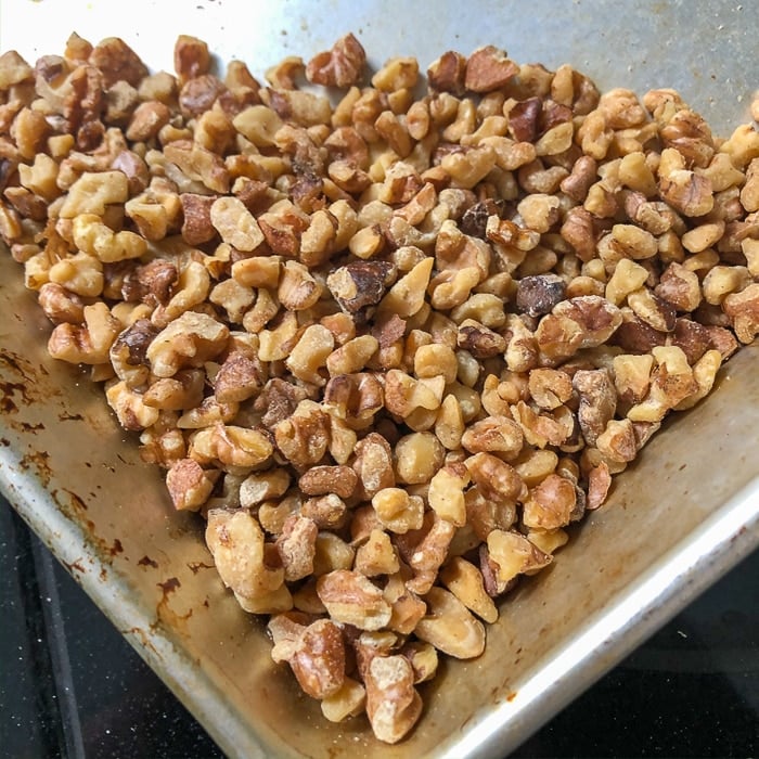 Toasted walnuts in an aluminum pan