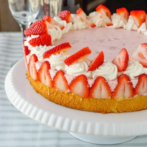 Strawberry Marshmallow Mousse Cake close up photo of finished cake on a white stand