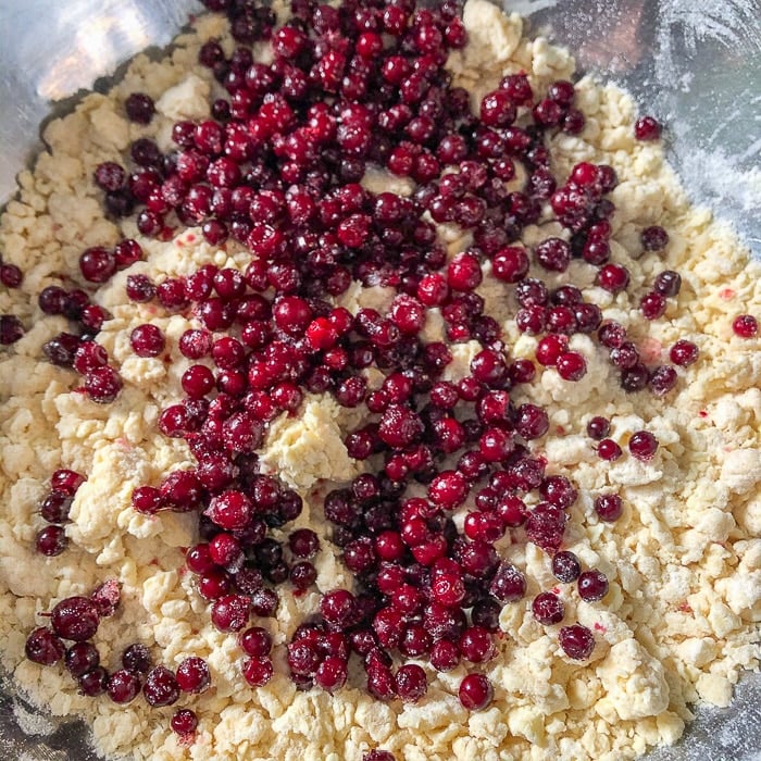 Adding the partridgeberries to the scones