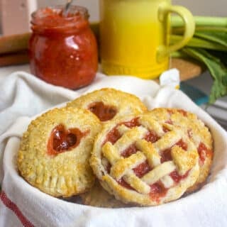 Oven Baked Hand Pies close up photo of pies in a teatowel lined basket