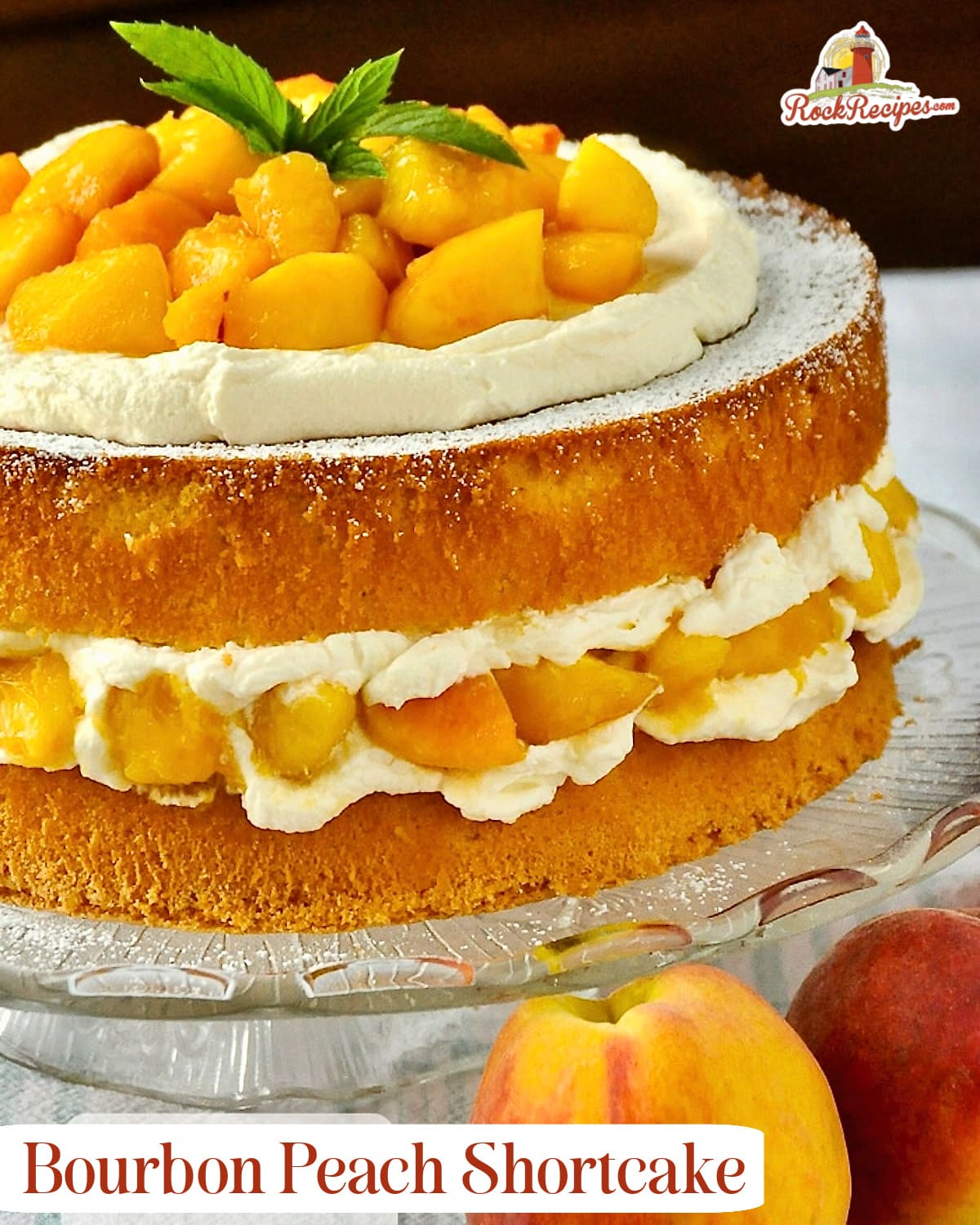 Bourbon Peach Shortcake close up photo of uncut cake with fresh peaches on the side with title text added for social media posts and Pinterest.