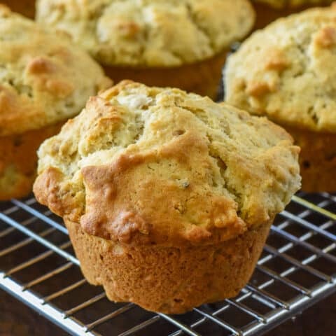 Multigrain Muffins. Close up of one muffin cooling with the others on a wire rack