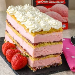 Strawberry Mille Feuille Ice Cream Cake on a slate serving plate with Chapman's ice cream package in the background